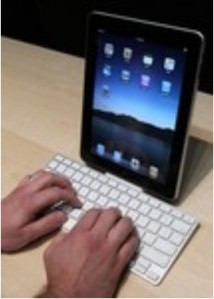 Someone using an external keyboard to type on an iPad